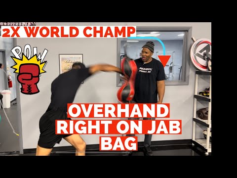 2X Heavyweight Boxing Champion of the World Teaches How To Throw The Overhand On The Jab Bag