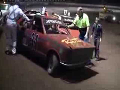 JUNIOR SEDAN LOOSES A WHEEL THEN CREATES A PILEUP @ MARYBOROUGH SPEEDWAY.