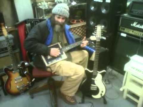 Bill Able at Bluestown Music testing one of his cigar box guitars[1].3GP