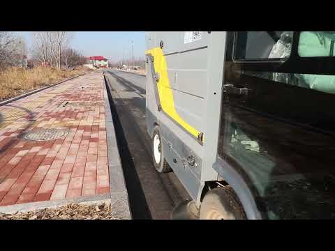Small Electric Road Sweeper and Washer Cleaning the Roads