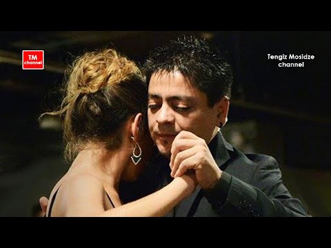  Carlos Espinoza  and  Noelia Hurtado Pitruzzella  are  dancing  to  the  tango  "  Guapeando  "  by  Solo Tango Orquesta  at  Planetango Moscow  in  2014