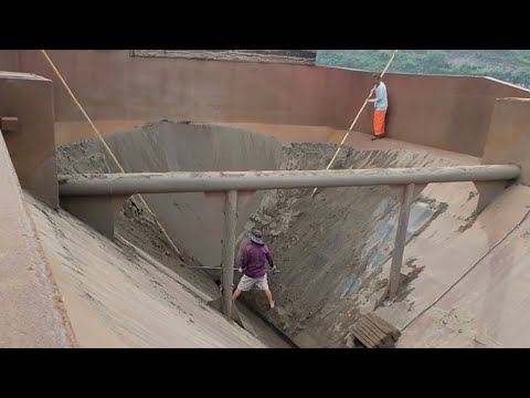 The barge unloads alluvial sand at the end, cleans barge and prepares to load white sand tomorrow