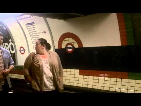 Piccadilly Circus Underground Tube Train Station London, UK,  with Escalator & Performer