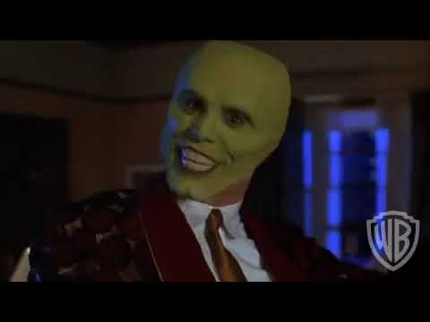 The Mask 1994 trailer still of Stanley Ipkiss in the yellow zoot suit and green face grinning at camera