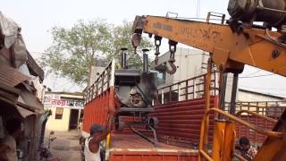 Crane Loading Black Tar coal Vessel in the Truck.