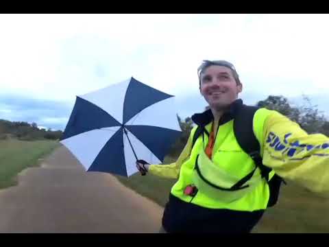 Skateboarding with umbrella in the wind