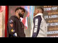 EFE AJAGBA STEPS TO STONE FACED FRANK SANCHEZ DURING FACE OFF AT FINAL PRESSER