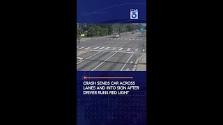 Crash sends car across lanes and into sign after driver runs red light