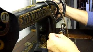 Loading thread on long bobbin of a Damascus sewing machine