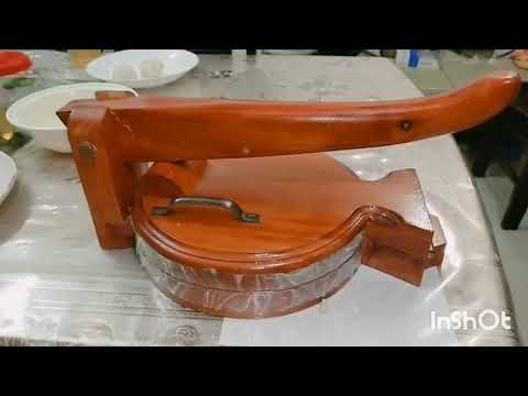 Round shaped wooden roti maker / pressure handheld appliance.