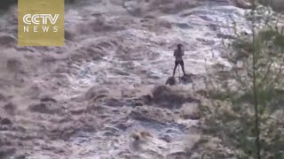 Shocking footage: Man stranded in middle of turbulent flood