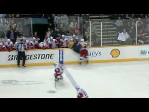 Darren Helm hits Patric Hornqvist into the bench