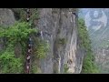 Chinese children climb 800m cliff to get home from school