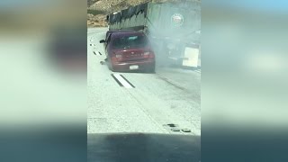 Truck Driver Doesn't Realize He's Dragging Car Along Highway for a Half Mile
