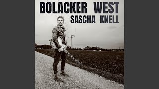 Kadr z teledysku Bolacker West tekst piosenki Sascha Knell