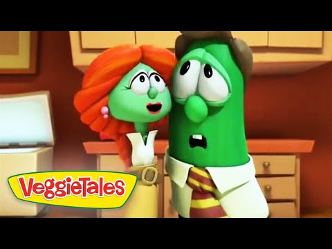 Two green veggie characters in a kitchen, a red-haired female and a green cucumber-like figure, look surprised as they stand near cabinets; VeggieTales logo in the bottom-left corner.
