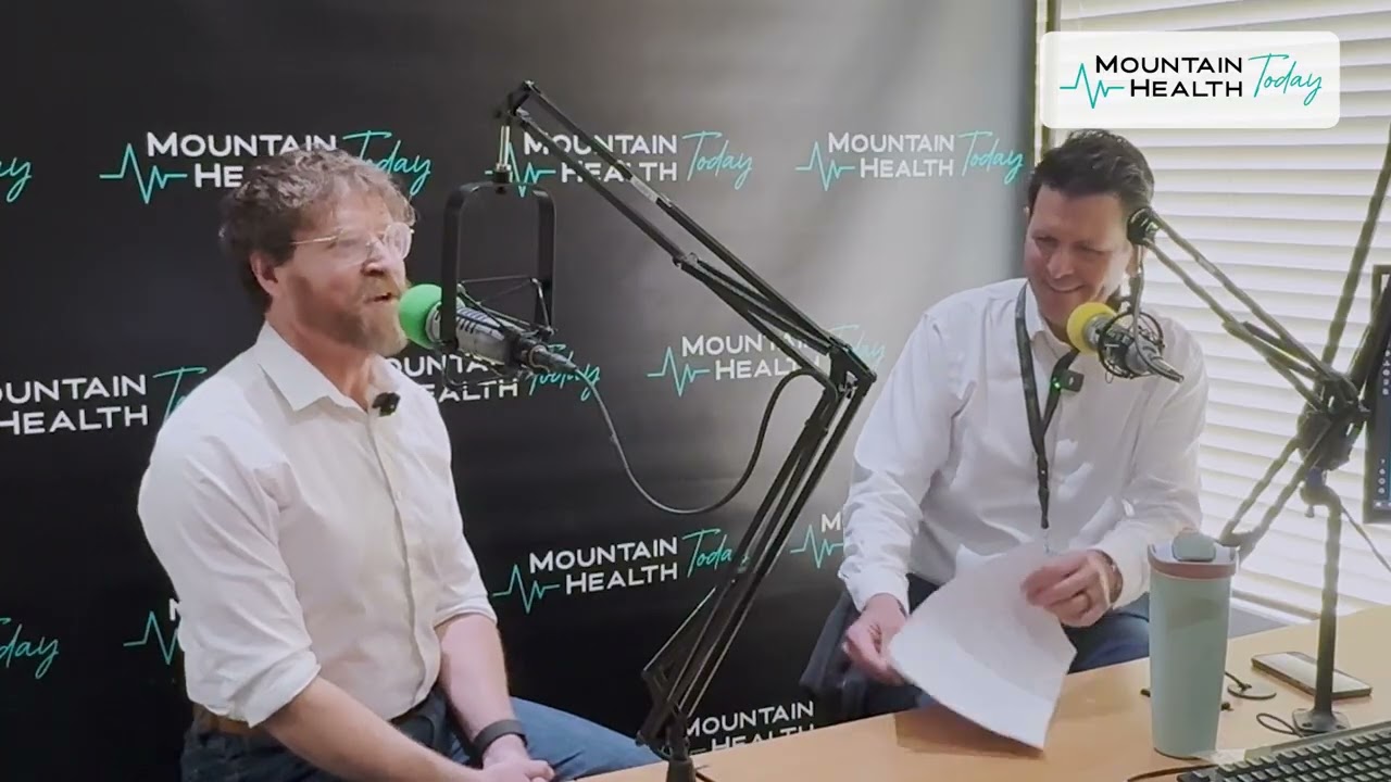 Dr. Brian Evans and Jonathan Lowe, Psychiatric Mental Health Nurse Practitioner, speaking into microphones in the Mountain Health Today podcast studio