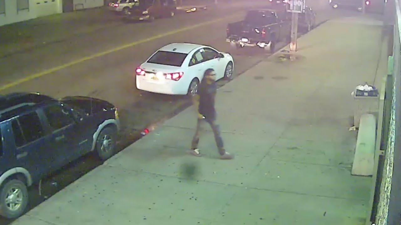 Surveillance video of man walking into liquor store before throwing bottle at TV