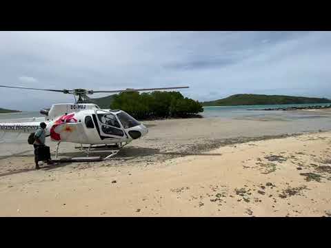Fiji - A helicopter drops a client and leaves the Yaqeta island.