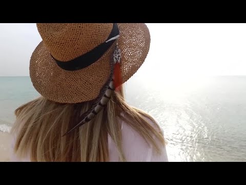 Woman Walking Down A Beach Stock Video