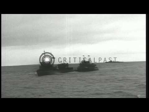 Flanked by US escorts, surrendered German submarine U-234 arrives at dock in Port...HD Stock Footage