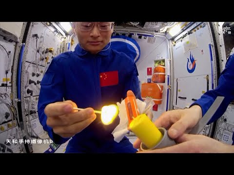 Chinese astronauts light candle with match on Tiangong space station to show flame behavior