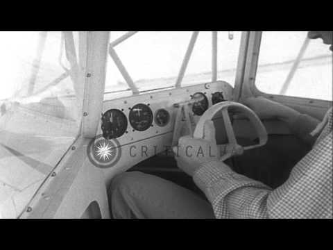 A small home-built bantam biplane makes its first flight in California. HD Stock Footage