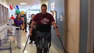 Robot Suit Gets the Wheelchair-Bound Walking (VOA On...