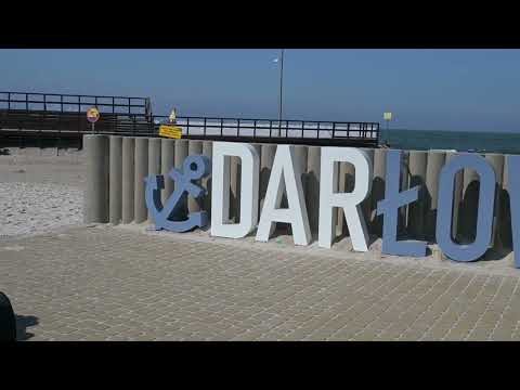 Darłowo in the summer by the sea. Port, lighthouse, beach, promenade. A walk around Darłowo.