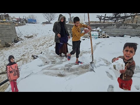 A happy day in the snow, building a snowman in the heart of the village