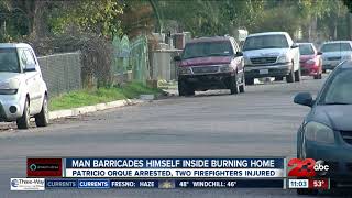 Man barricades himself inside burning home