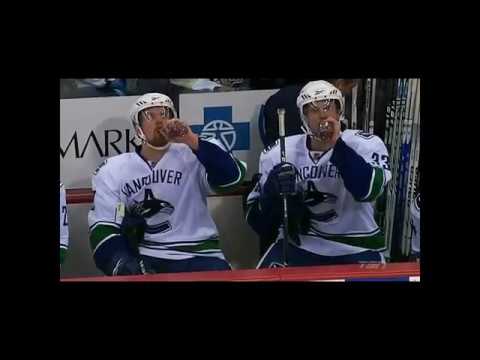 The Sedin Twins having a drink at the bench