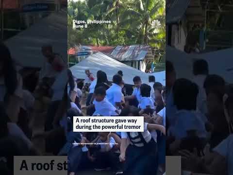 Students are rocked back and forth during 7.8-magnitude Philippines earthquake
