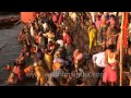 Devotees take ritual bath in Ganga river to mark the ...