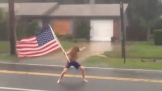 Florida crazy man challenges hurricane Matthew with American flag in hand.