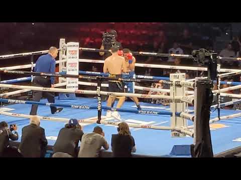 Lindolfo Delgado landing uppercuts and hooks on his opponent in the final seconds of his bout 14-0