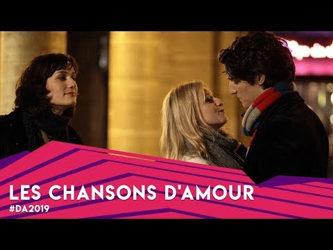 Trailer frame of the trio walking near Bastille, music cue building under dialogue
