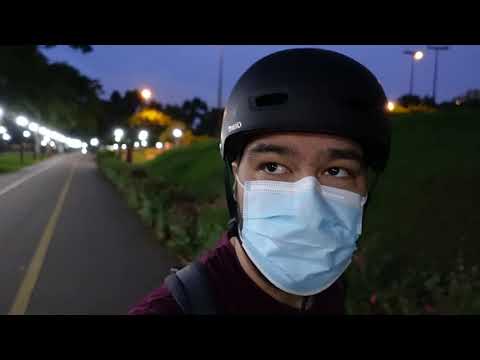 Thumbnail image for my youtube video "Early morning skate". It is me wearing my helmet and mask with the park in the background. The sidewalk lights are lit because it is still in the early hours of the day before the sun has fully risen.