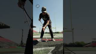 the finishing touches of paint on the turf before the REDBLACKS football game