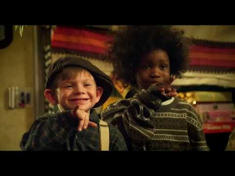 Trailer frame: stage lights on the kids’ band, microphones ready, audience murmuring before the talent show