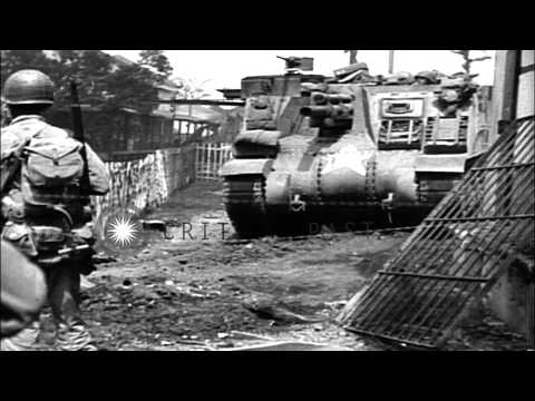 A crew fires anti tank gun and uses a flame thrower on a building in Ermita distr...HD Stock Footage
