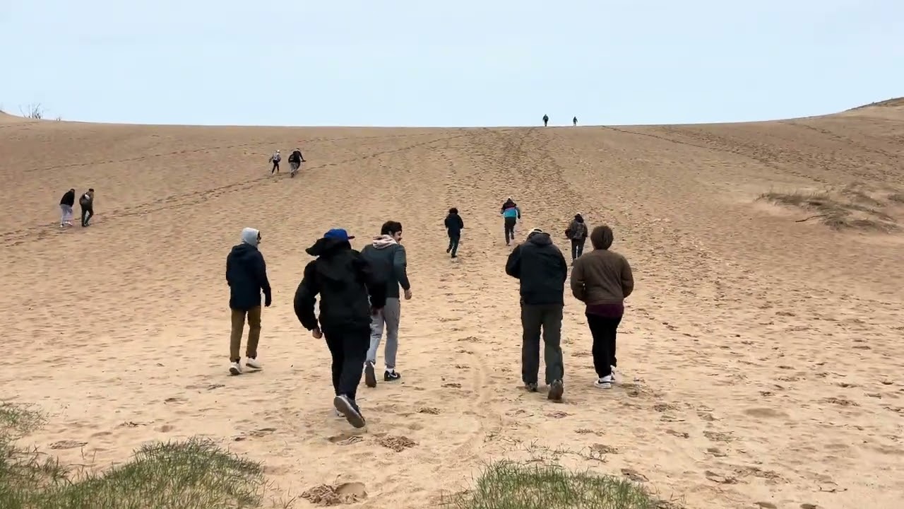 Students running up Sleeping Bear Sand Dunes