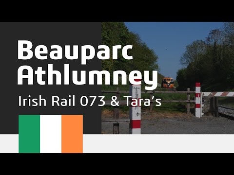 Irish Rail 073 in retro white stripe livery hauls empty Tara wagons passed Beauparc and Athlumny 4K