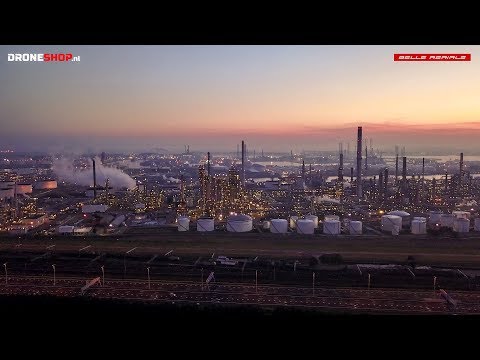 Drone fly by at sunrise of the industrial area of the port of Rotterdam