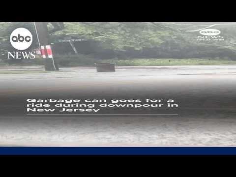 Garbage can goes for a ride during downpour in New Jersey