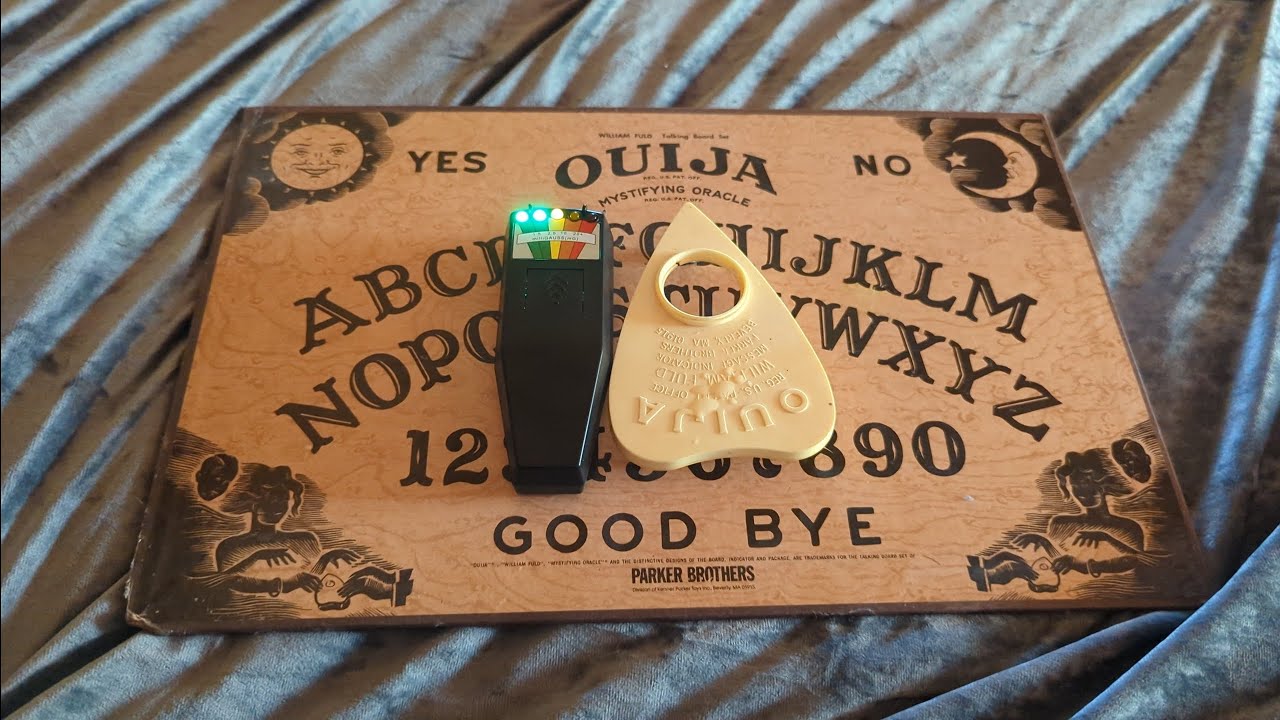 What happens when holy water is sprinkled on a Ouija board?