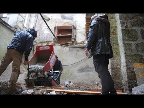 Pouring the foundation for the wall.