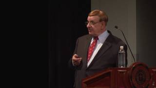 Dr. Weston Fields on stage giving his talk, How Can the Dead Sea Scrolls Help Us Understand the New Testament?