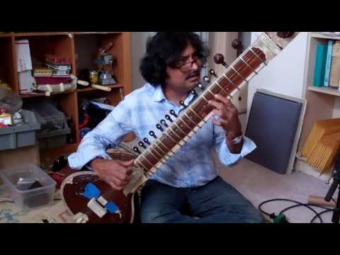 Indrajit Banerjee trying Rain City Music resin sitar bridge