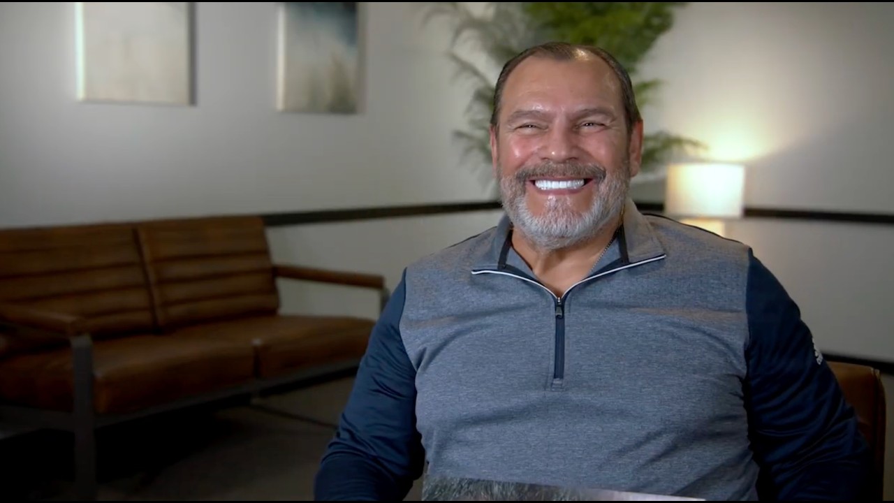Patient smiling after receiving dental implants